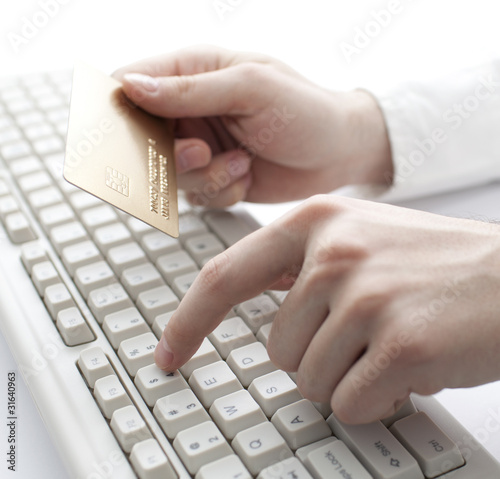 Photo: Paying with gold credit card. Shallow DOF Paying with gold credit card. Shallow DOF