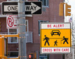 Warning sign at a dangerous, confusing and busy cross-walk.