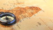 Compass raised on a worldmap