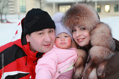Photo: mother and father kept his little daughter, winter mother and father kept his little daughter, winter