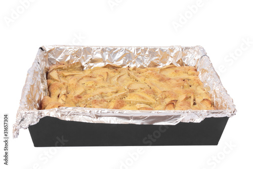 Photo: Apple pie on a baking sheet. Isolated on white Apple pie on a baking sheet. Isolated on white