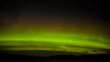 Green northern lights and myriad of stars