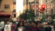 Time-lapse people crossing across busy traffic in downtown.
