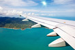 Blue sky and sun view over the wing of the plane.