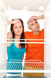 Couple with empty refrigerator