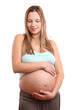 Pregnant woman touching her belly with hands