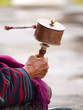 An older women spinning her prayer wheel An older women spinning her prayer wheel