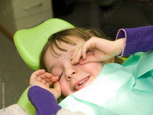 Photo: Little girl after dental examination in anesthesia Little girl after dental examination in anesthesia
