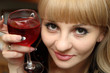 Young woman with bocal of red wine.
