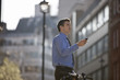 A businessman checking directions using his mobile phone