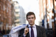 A businessman carrying his dry cleaning