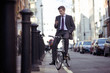 Foto: A businessman on his bicycle, looking at his mobile phone A businessman on his bicycle, looking at his mobile phone