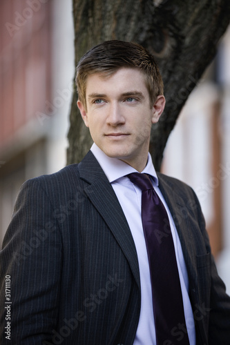 Photo: Portrait of a businessman standing outside Portrait of a businessman standing outside