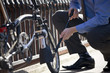 Foto: A businessman pumping up the tires on his bicycle A businessman pumping up the tires on his bicycle