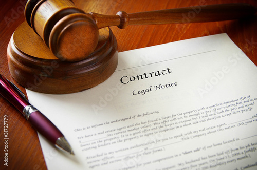 Photo: legal gavel and a business contract legal gavel and a business contract