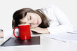 Business woman sleeping on table in office