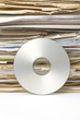Stack of old paper files and  silver cd