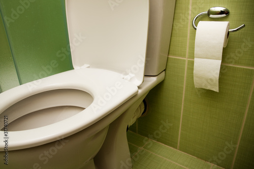 Photo: Toilet seat and paper in bathroom Toilet seat and paper in bathroom