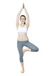 Fit girl doing tree yoga pose