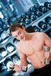 Young man lifting bumbbell in sport club Young man lifting bumbbell in sport club