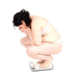 Foto: squats on scale young fat woman in underwear squats on scale young fat woman in underwear