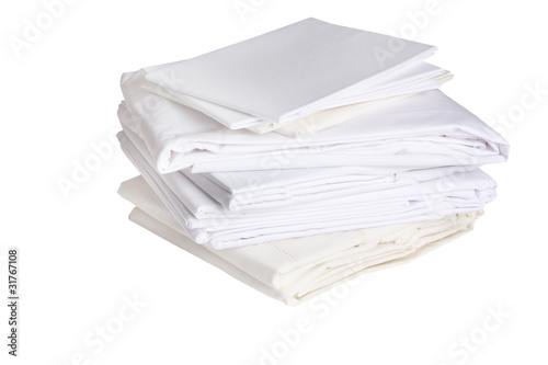 Photo: pile of ironed white bed sheets pile of ironed white bed sheets