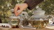 Woman mixes glass of tea outdoors