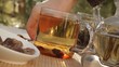 Woman mixes glass of tea outdoors
