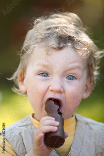 Photo: kleiner Junge nascht einen Osterhasen kleiner Junge nascht einen Osterhasen