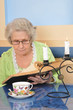 elderly lady holding a book