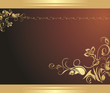 Golden floral ornament on the brown background Golden floral ornament on the brown background