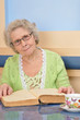 woman with the book looks into the camera