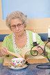 elderly woman holding a book for reading