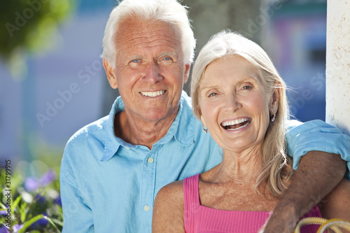Photo: Happy Senior Couple Smiling Outside in Sunshine Happy Senior Couple Smiling Outside in Sunshine