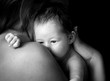 Newborn baby girl on his Mothers shoulder