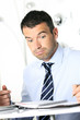 busy man hiding behind a stack of files