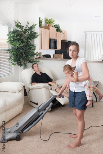 Photo: A Mother Trying To Vacuum While The Father Sits Around A Mother Trying To Vacuum While The Father Sits Around