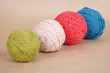 four multicolored clews on brown paper background