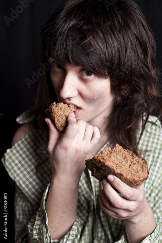 Photo: beggar woman eating bread beggar woman eating bread