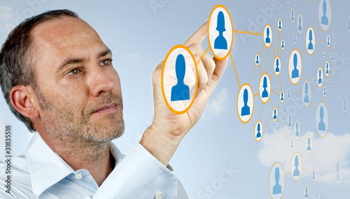 Photo: Businessman works with social network Businessman works with social network