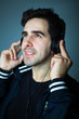 Handsome young man listening the music in headphones