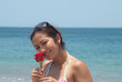 Young oriental lady smells a rose