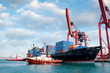Tug boats pulling out container ship