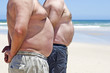 Foto: Close up of two obese fat men of the beach Close up of two obese fat men of the beach