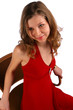 Photo: Smiling girl sits in chair. Smiling girl sits in chair.