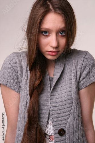 Photo: Portrait of pretty girl in grey woolen shirt. Portrait of pretty girl in grey woolen shirt.