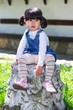 Small girl sitting in the garden Small girl sitting in the garden