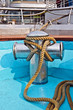Metal bollard with rope at a ship deck