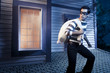 Photo: Thief walking on the roof of a house at night Thief walking on the roof of a house at night