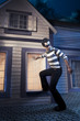 Photo: Thief walking on the roof of a house at night Thief walking on the roof of a house at night